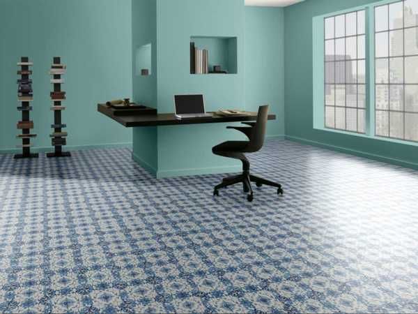 Stylish modern room with eye-catching patterned flooring in bold colors, reflecting updated interior design trends for offices and homes.